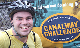 Smiling person nect to the Canalway Challenge logo