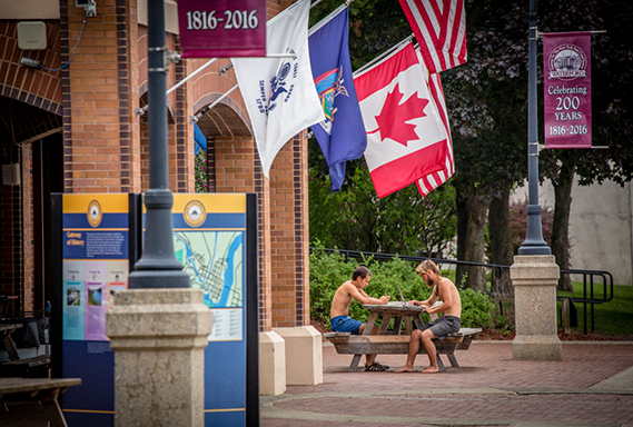 Visitor Center in Waterford with colorful flags and people at a picnic table